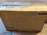 a box that is sitting on the floor in front of a refrigerator