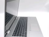 a silver laptop with a black keyboard on a white surface