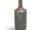 a vase that is sitting on a white surface