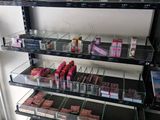 a lot of lipsticks on the shelves in the store