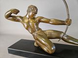 bronze statue of a man with a bow and arrow on a black base