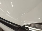 a close up of a car ' s headlight on a white car