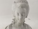 a statue of a woman with a flower in her hair
