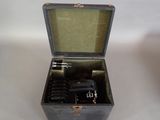 a metal box with a gun in it on a table
