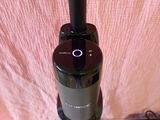 a vacuum that is sitting on a table next to a cell phone