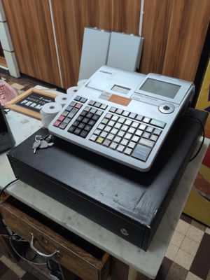 a calculator sitting on top of a table in a kitchen