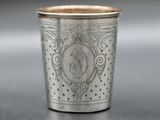a close up of a silver cup sitting on a table