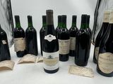 several bottles of wine are lined up on a table