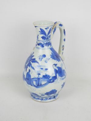 a blue and white vase with a bird design on it