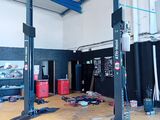 une photo d'un garage avec beaucoup d'outils sur le sol