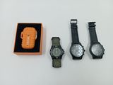 three watches and a lighter in a box on a table