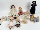 a lot of dolls that are sitting on a white surface