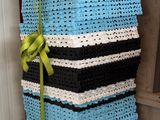 a stack of baskets with a green ribbon tied to them