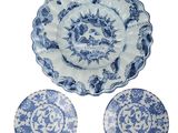 three blue and white plates and a bowl on a white background