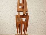 a wooden sculpture that is on a wooden table