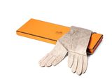 une boîte orange sur laquelle sont posés une paire de gants