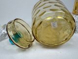 a glass jar with a lid and a glass bottle with a lid and a glass with a lid