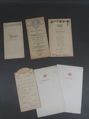 several old papers are sitting on a black surface