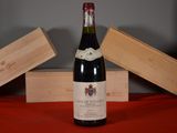 a bottle of wine sitting on a table next to two wooden boxes
