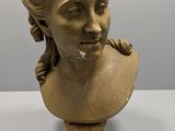 a close up of a bust of a woman on a table