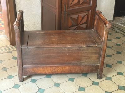a wooden bench sitting in front of a door