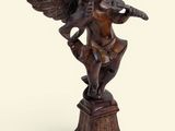 an image of a statue of an angel playing a flute