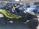 a yellow and black utv parked in a parking lot