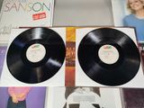 two black vinyl records sitting on a table next to each other