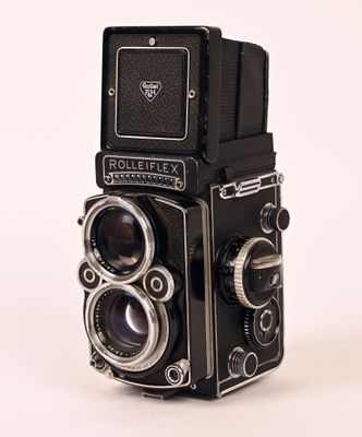 a black camera with a white background and a white background