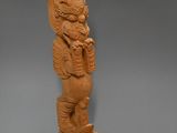 carved wooden figurine of a man and a woman on a horse