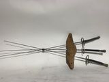 a knife holder with four knives on top of it