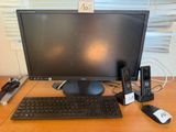 a computer monitor, keyboard, mouse, and other electronics on a desk