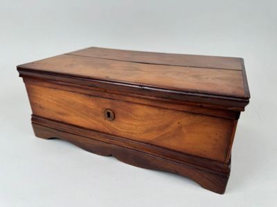 an old wooden box sitting on top of a white surface