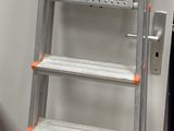 a ladder that is leaning against a wall next to a trash can