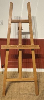 a wooden easel that is sitting on the floor