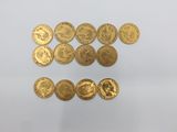 a pile of gold coins sitting on top of a white surface