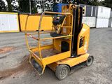 the forklift is sitting on the ground in front of a container