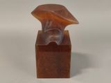 statue of a woman ' s head on a wooden base