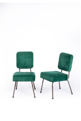 pair of green velvet chairs with metal legs and a green upholstered seat