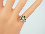 an image of a woman ' s hand with a ring on it