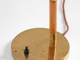 an image of a gold colored lamp on a white surface