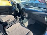 the interior of a small car with a steering wheel and dashboard