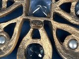 an image of a gold broochle with black stones and pearls
