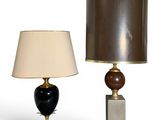 two lamps on a table with a lamp shade on top of them