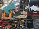 a pile of tools sitting on the floor next to a box