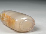 a bottle with a liquid inside of it sitting on a table