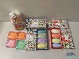 a box of soaps sitting on a table next to a jar of soaps