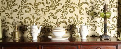 a dresser with a bunch of vases on top of it
