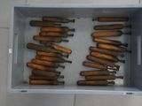 a lot of wooden pegs in a box on the floor