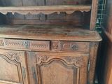an old wooden china cabinet with two shelves and a door